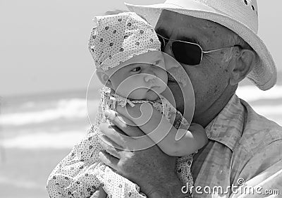 Grandpa is holding a little granddaughter Stock Photo