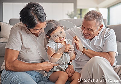 Grandparents, girl and sofa in house, happy and playing together in bonding time. Grandmother, grandpa and child on Stock Photo