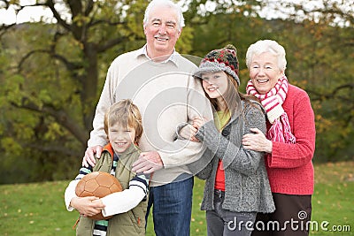 Grandparents With Grandchildren Holding Football Stock Photo