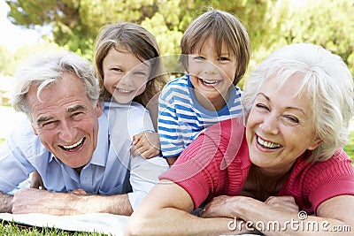 Grandparents And Grandchildren In Park Together Stock Photo