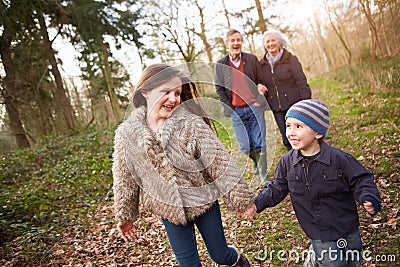 Grandparents With Grandchildren On Walk In Countryside Stock Photo