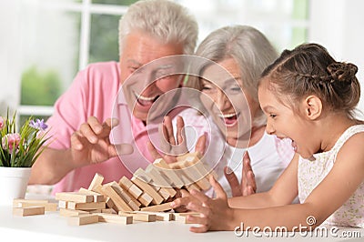 Grandparents with granddaughter playing together Stock Photo