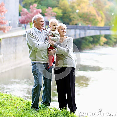 Grandparents with granddaughter walking in the park Stock Photo