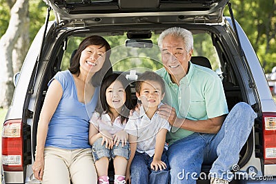 Grandparents with grandkids in tailgate of car Stock Photo