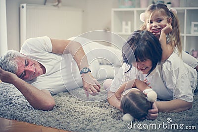 Grandparents have play with granddaughters. Stock Photo