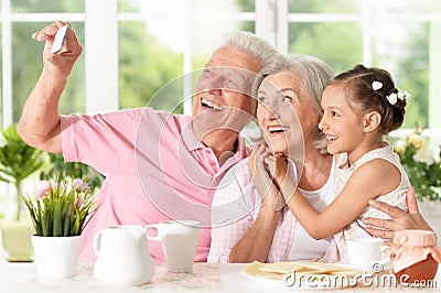 Grandparents and little girl taking selfie Stock Photo