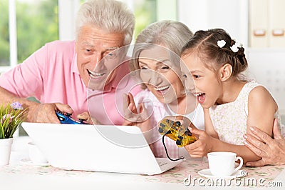 Grandparents and little girl using laptop Stock Photo