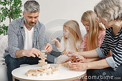 Grandparents play tower game with two girls Stock Photo