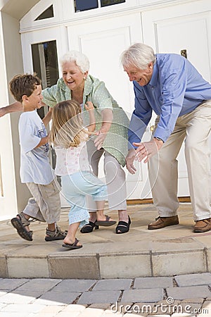 Grandparents welcoming grandchildren Stock Photo