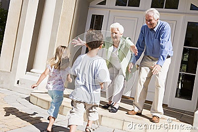 Grandparents welcoming grandchildren Stock Photo