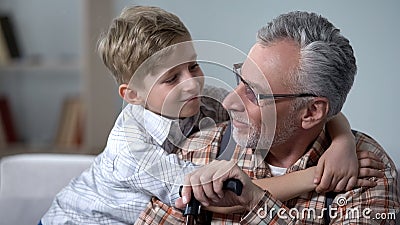 Grandson embracing grandfather with love, precious family minutes, elderly care Stock Photo