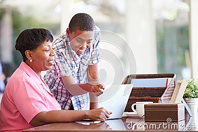 Grandson Helping Grandmother With Laptop Stock Photo