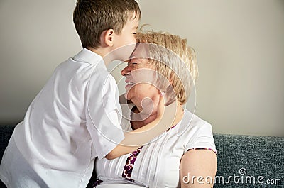 Grandson kissing his grandmother Stock Photo