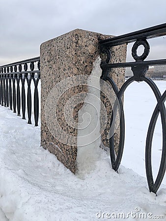 granite pillar and cast iron embankment fence Stock Photo