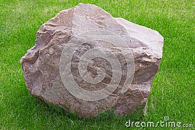 The granite stone on the grass Stock Photo