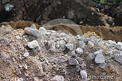 granite stones, sand and earth, dug during the extraction of peat on-site preparation for construction of the road Stock Photo