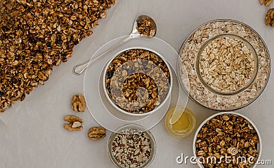 Just baked granola, bowls and jars with cereal and honey Stock Photo