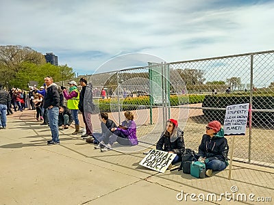 Demonstrators take a break at the March for Science in Chicago. Editorial Stock Photo