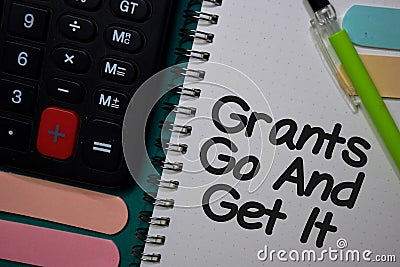 Grants Go and Get It write on a book isolated on Office Desk Stock Photo