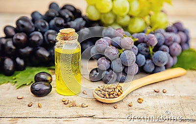 Grape seed oil in a small bottle. Selective focus Stock Photo
