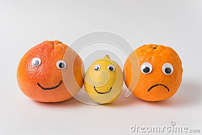 Grapefruit, lemon and orange with funny faces on white background. optimist and pessimist concept Stock Photo