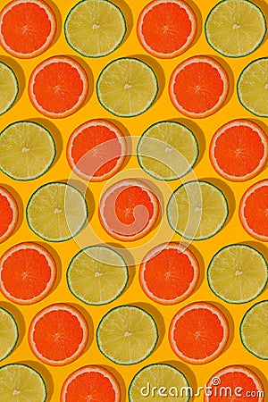 Grapefruit and lime pattern on yellow background. Minimal flat lay concept. Stock Photo