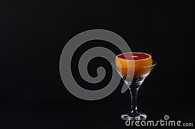 Grapefruit in a martini glass on a black background. Stock Photo