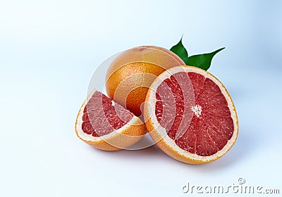 Grapefruit whole, cut in half and a quarter on a white background close-up. Stock Photo