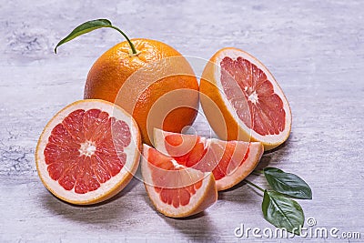 Grapefruit whole, half and slice, green leaf, juicy ripe on a gray background Stock Photo