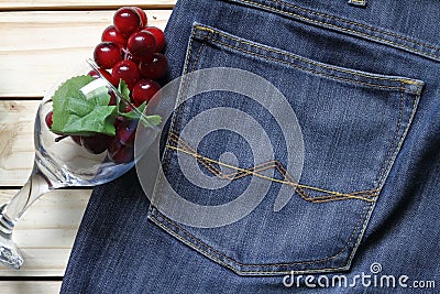 Grapes on a jeans and glass . wood background . Stock Photo