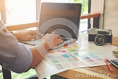 Graphic design and color swatches and pens on a desk. Architectural drawing with work tools and accessories. Stock Photo