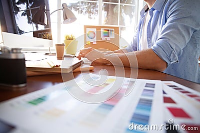 Graphic design and color swatches and pens on a desk. Architectural drawing with work tools and accessories. Stock Photo