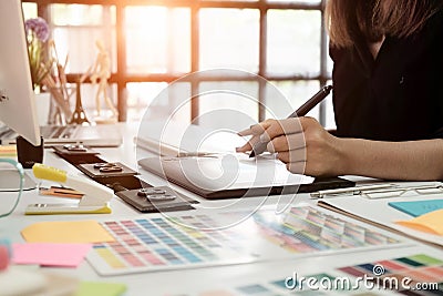 graphic design desk hand using mouse pan sketch device on creative desk. Stock Photo