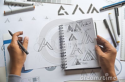 Graphic designer development process drawing sketch design creative Ideas draft Logo product trademark label brand artwork. Stock Photo
