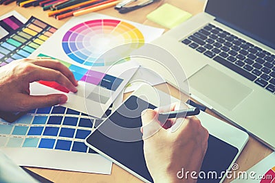 Graphic designer drawing on graphics tablet at workplace Stock Photo