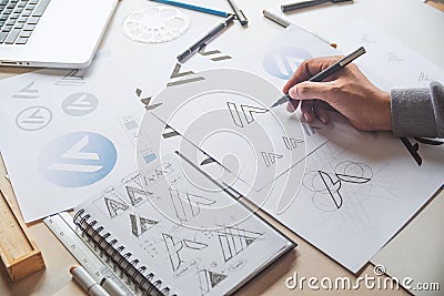 Graphic designer drawing sketch design creative Ideas draft Logo product trademark label brand artwork. Graphic designer studio Stock Photo