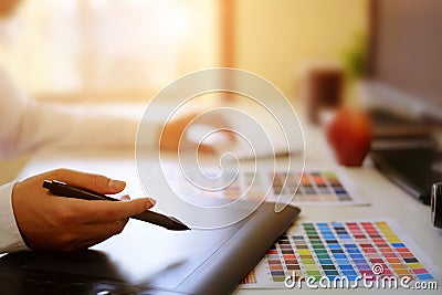 Graphic designer hands using digital tablet and computer. Stock Photo