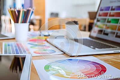 Graphic designer object tool and color swatch samples at workspace Stock Photo