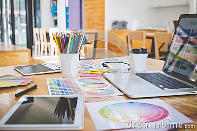 Graphic designer object tool and color swatch samples at workspace Stock Photo