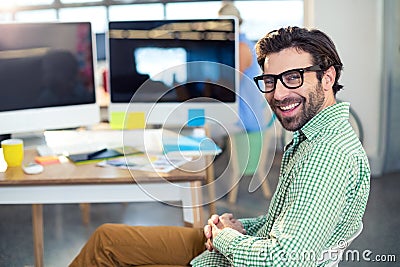 Graphic designer sitting on chair in office Stock Photo