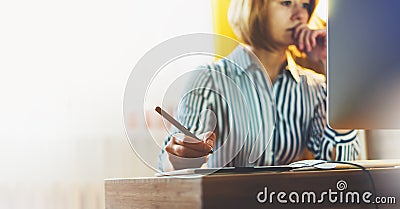 Graphic designer working at office with digital stylus on background monitor computer at night, hipster manager using device pen, Stock Photo