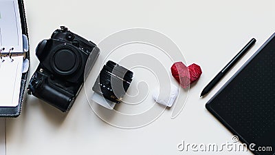 Graphic designer workstation with dslr, lens, agenda, stylus and heart printed in 3d Stock Photo