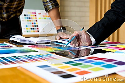 Graphic designers use the tablet to choose colors from the color Stock Photo