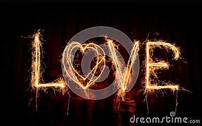 graphics of a burning love inscription on a dark background Stock Photo