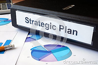 Graphs and file folder with label Strategic plan. Stock Photo