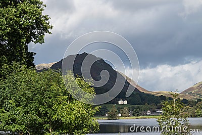 Grasmere, Cumbria, Lake and village, overlooked by Helm Crag Stock Photo