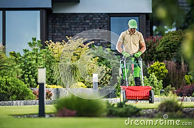 Grass Fertilizing Using Push Spreader Stock Photo