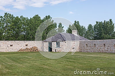 Grass field next to the corner building of Lower Fort Garry in Canada Editorial Stock Photo