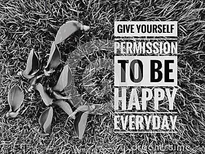 Grass and flowers with phrase GIVE YOURSELF PERMISSION TO BE HAPPY EVERYDAY Stock Photo