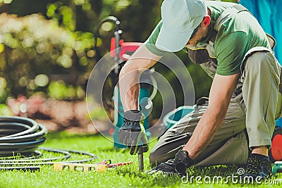 Grass Sprinklers Installation Stock Photo